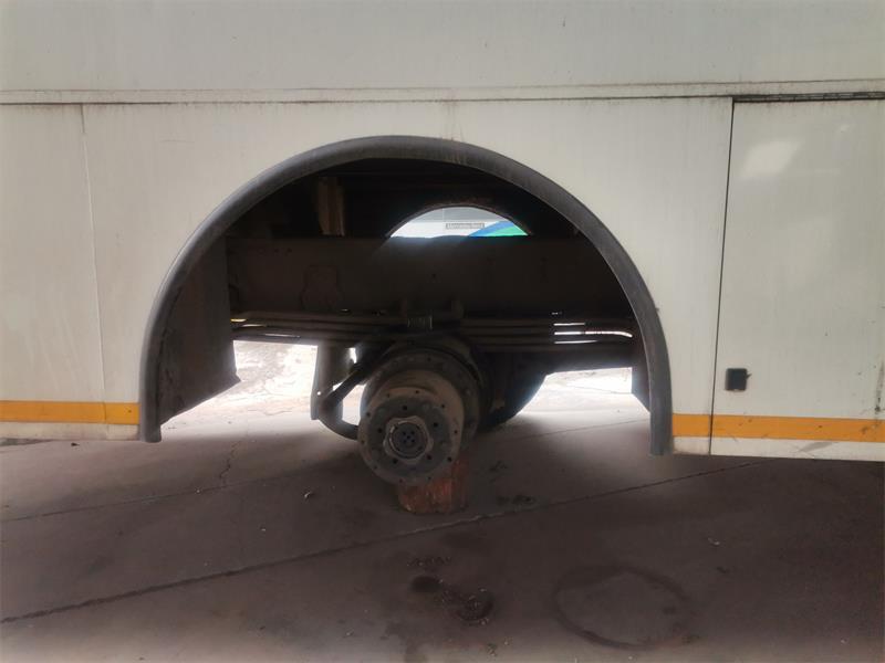 A white Ekurhuleni metro bus standing on bricks.
