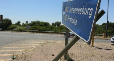 A crumbling road sign on the Rondebult Road off-Ramp in Boksburg.