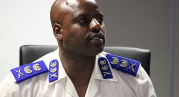 mugshot of Julius mkhwanani in a full police uniform