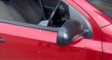 A red bullet-riddled car