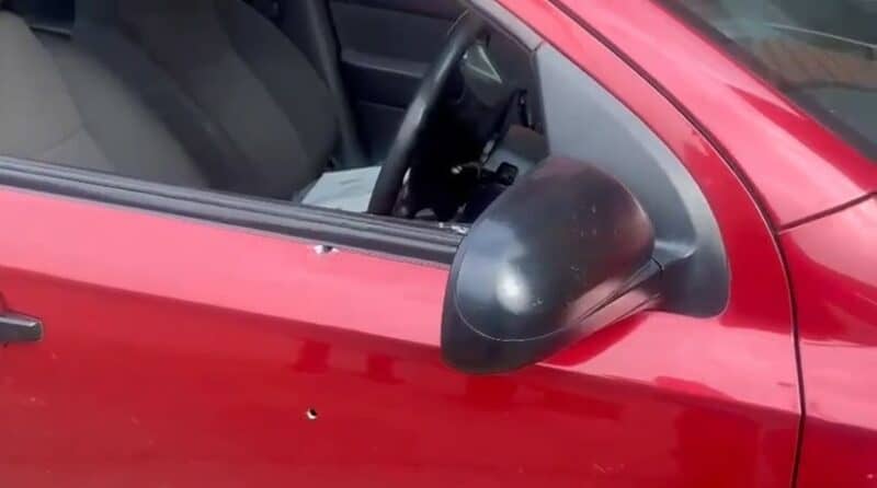 A red bullet-riddled car