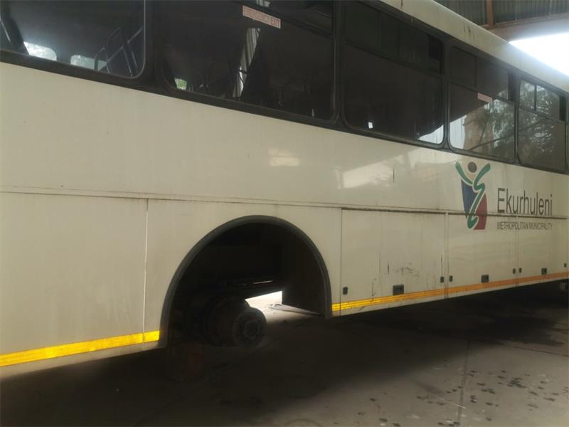 A white ekurhuleni municipal bus standing on bricks after it was stripped of its wheels by criminals