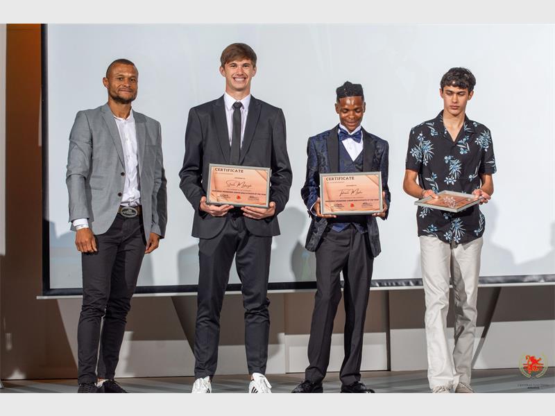 Four sportsmen receiving their accolades.