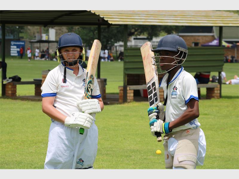 Two players in their cricket gear.