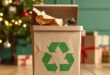 Recycling container standing in front of a Christmas tree