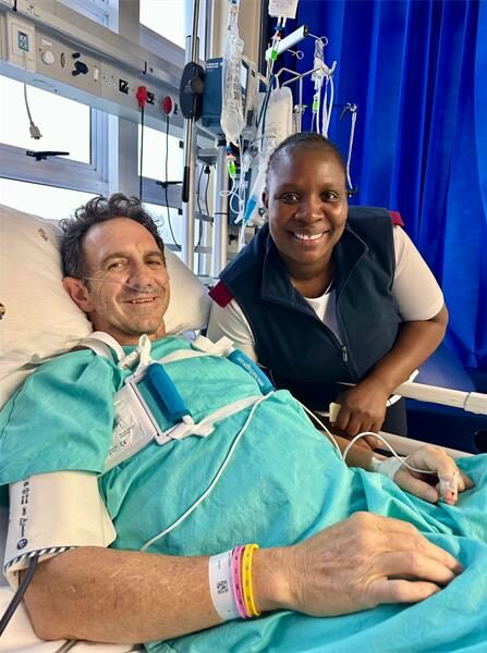 A man sleeping in a patient's bed in hospital