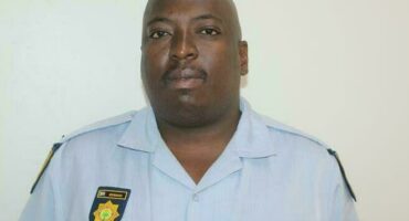 A black man in his police uniform.