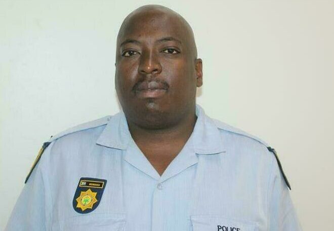 A black man in his police uniform.