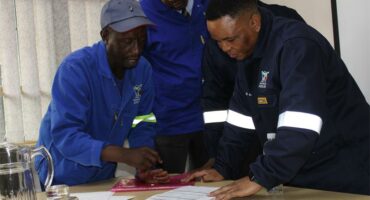 Three black men in work suits