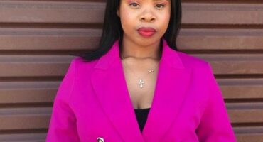 A woman dressed in a purple blazer