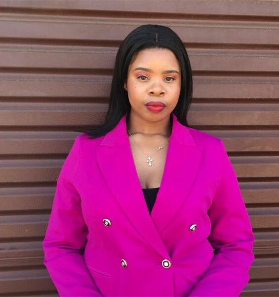 A woman dressed in a purple blazer