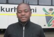 MMC for Roads and Transport Planning, Andile Mngwevu, standing in front of a metro bus.