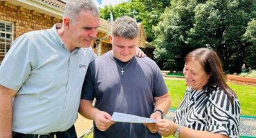 Parents, mother and father, check their son's NSC results