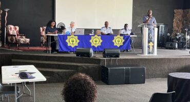 Uniformed police officials seated together.