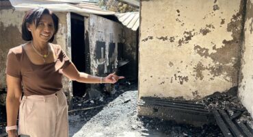 A woman pointing to where the fire engulfed.