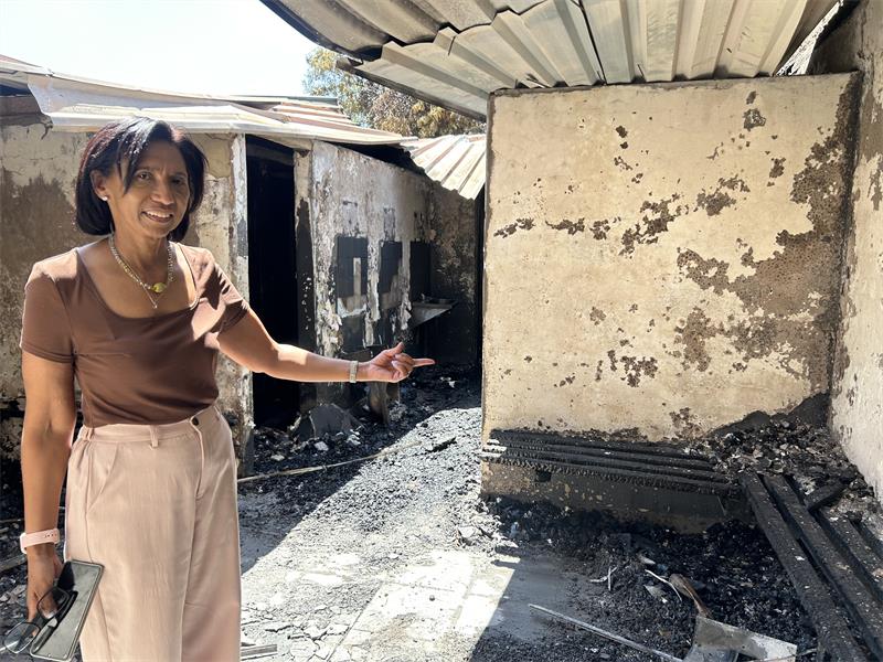 A woman pointing to where the fire engulfed.