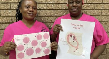 Black women dressed in pink srubs.