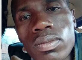 A black dressed in a green jacket.