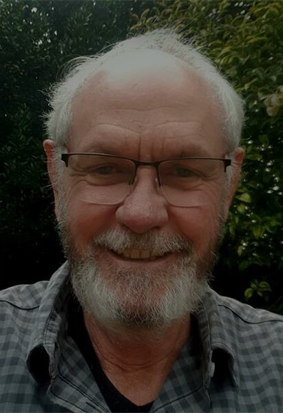 a profile photo of a man with gray hair