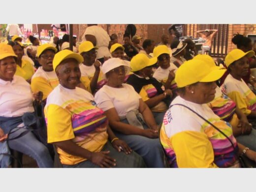 a group of women in yellow tops