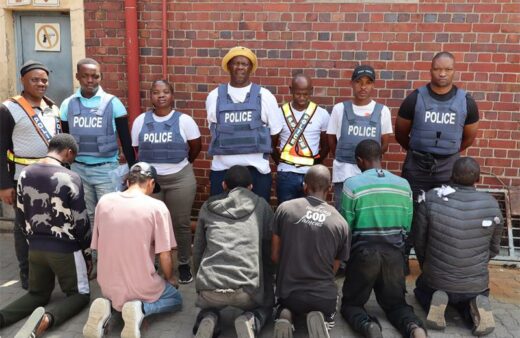 A team of police officers and arrested suspects