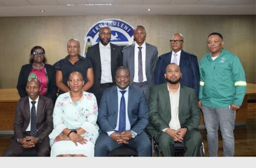 A group of government officials posing for the camera