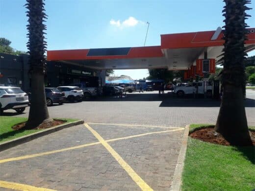 A staff member scrubs the forecourt of the Dalview petrol station