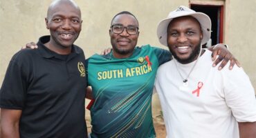 Three black men posing for a photo