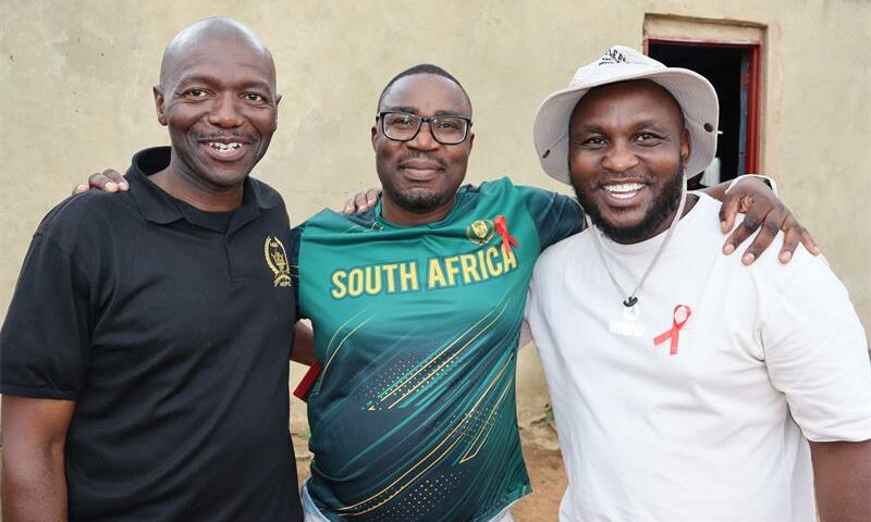 Three black men posing for a photo