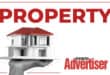 Black and white image of a hand holding a model of a house with a red roof with the word Property in red and the Boksburg Advertiser logo.