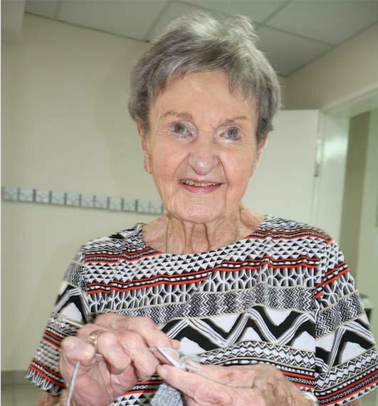 an elderly person knitting