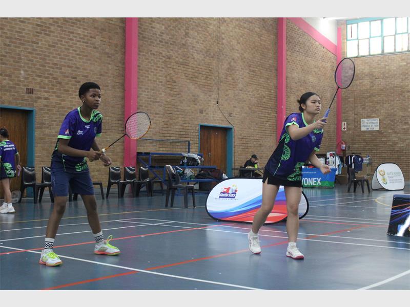 Two badminton players in action. 