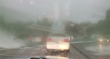 Cars push through heavy rainfall
