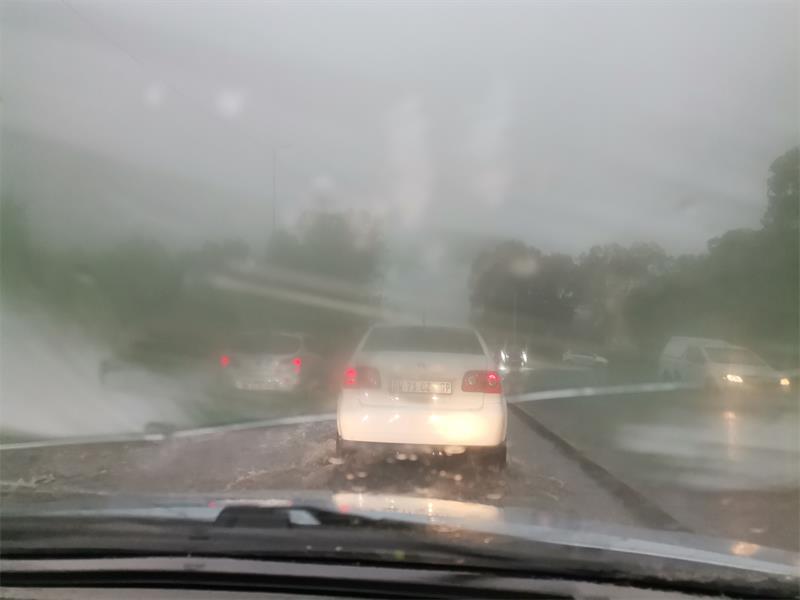 Cars push through heavy rainfall