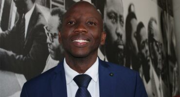 a black man in blue suits