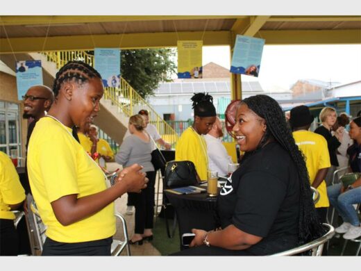 two women, one in black top and the other wearing a yellow top