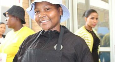 a woman wearing black bib apron