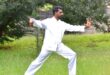 An Indian man dressed in white outfit