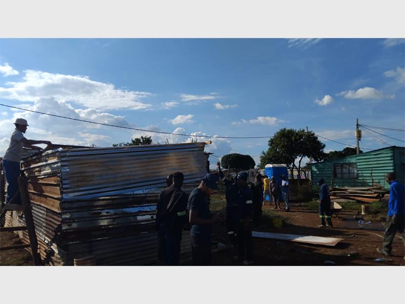Neighbours worked together to reconstruct the three-room shack, demonstrating solidarity and support for the affected family.