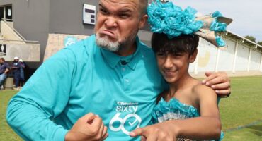 Jason Goliath dressed in sixty60 t-shirt congratulates the winner of the Sixty60 dress-up competition at CBC Boksburg.