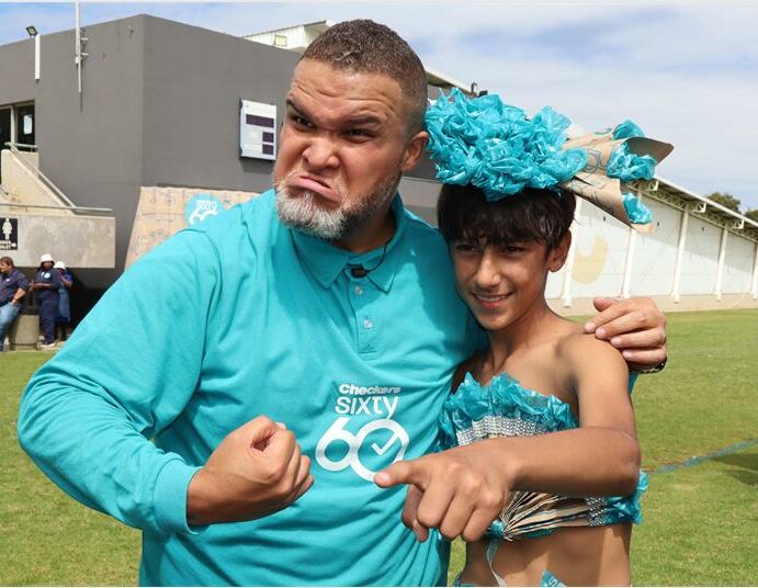 Jason Goliath dressed in sixty60 t-shirt congratulates the winner of the Sixty60 dress-up competition at CBC Boksburg.