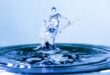 Drop of water splashing into a body of water