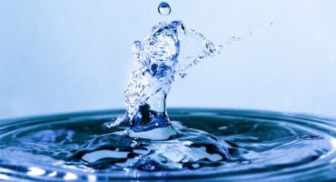 Drop of water splashing into a body of water