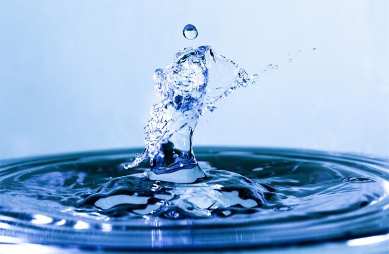 Drop of water splashing into a body of water
