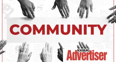 A black and white image of hands reaching into the word Community in red and the Boksburg Advertiser logo.