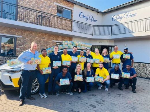 a group of people dressed in yellow and blue t-shirts, and holding Easter egg boxes