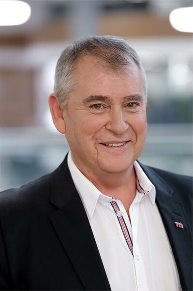 a man in a white shirt and black blazer