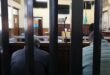 Two men sit side by side in the court dock during proceedings at the Boksburg Magistrate’s Court, as their bail application is heard.