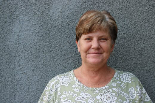 a mugshot of a woman standing against a wall