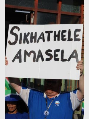 A man holding a placard high up